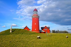 red lighthouse Bovbjerg Fyr illuminated by the light of the setting sun